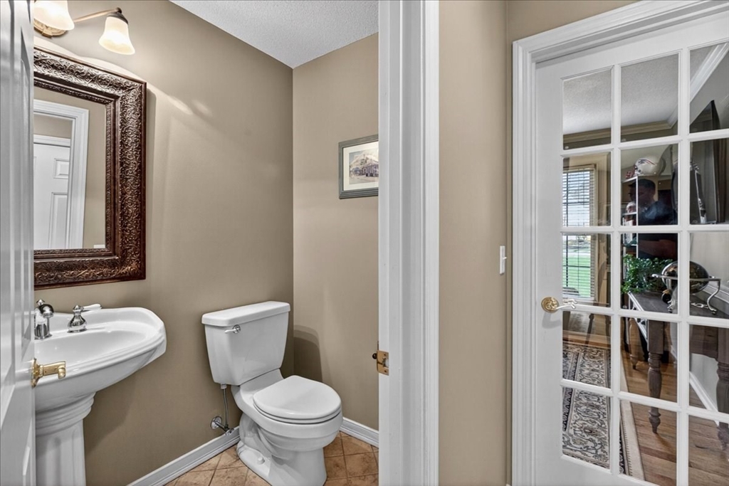 1318 Piper Road West Springfield, MA 01089 - Photo 23 of 42 a bathroom with a toilet a sink and mirror