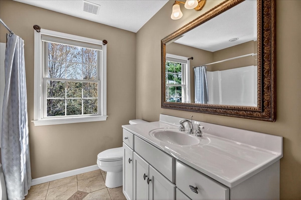 1318 Piper Road West Springfield, MA 01089 - Photo 34 of 42 a bathroom with a granite countertop sink toilet and a mirror