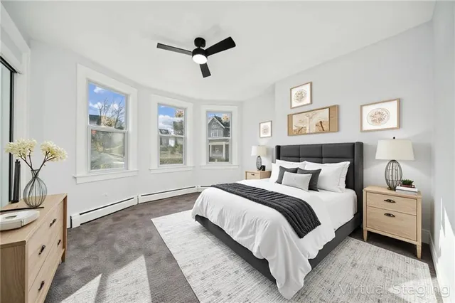 a bedroom with a large bed and a window