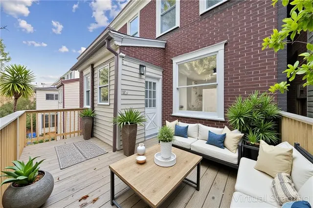 a outdoor living space with a couch and chairs