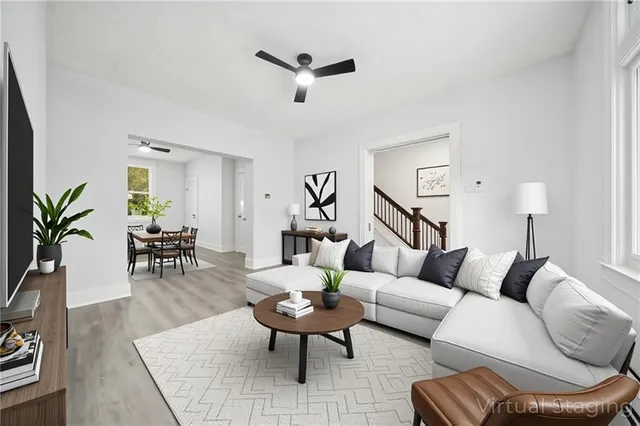 a living room with furniture or couch and a wooden floor