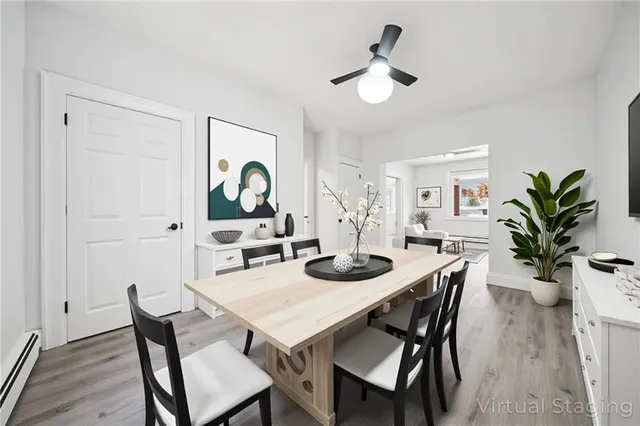 a view of a dining room with furniture and wooden floor