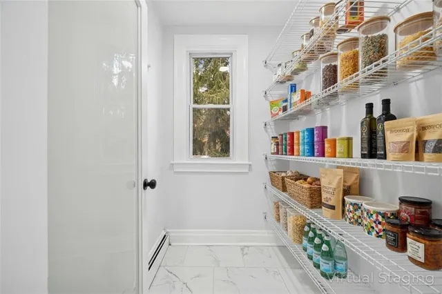 a view of an entryway with paintings on the wall