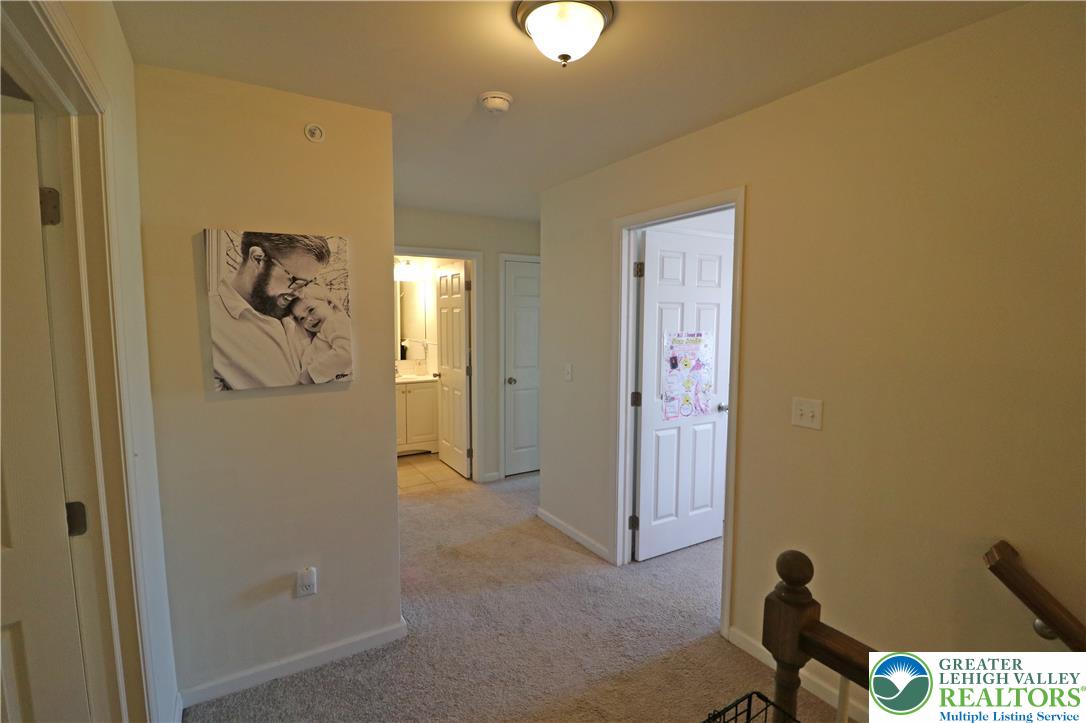 4502 Benjamin Court Emmaus, PA 18049 - Photo 32 of 53 A welcoming hallway provides seamless access to multiple rooms, highlighted by soft carpet underfoot.