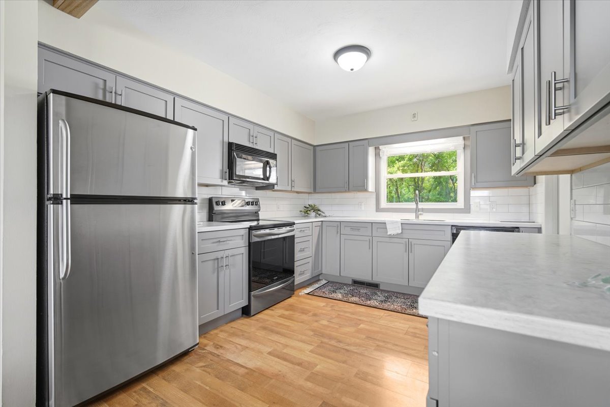203 Highview Drive Eureka, IL 61530 - Photo 9 of 49 a kitchen with a refrigerator a sink and a stove top oven