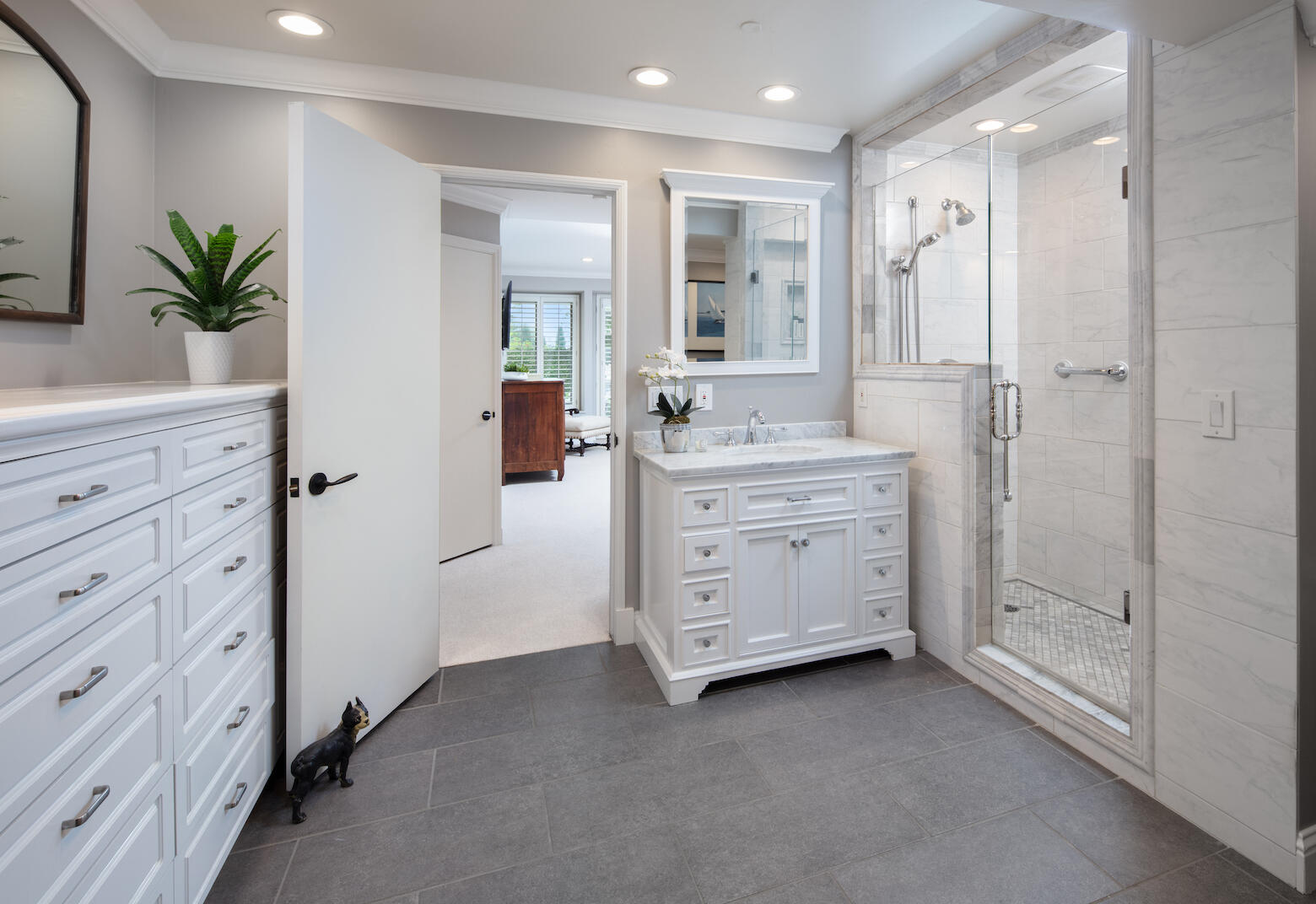 1975 Inverness Lane Montecito, CA 93108 - Photo 16 of 22 a bathroom with a double vanity sink a large mirror a shower and a bathtub