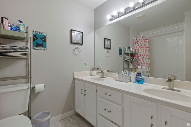 962 Independence Avenue Provo, UT 84604 - Photo 16 of 31 Bathroom with double vanity, a shower with curtain, and light marble finish flooring