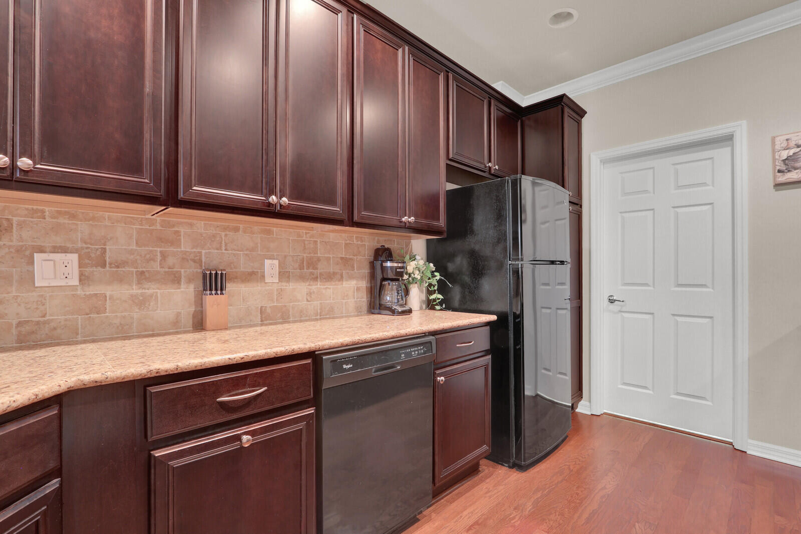 3277 East Mallory Boulevard Jupiter, FL 33458 - Photo 14 of 44 a kitchen with granite countertop stainless steel appliances wooden cabinets and a sink