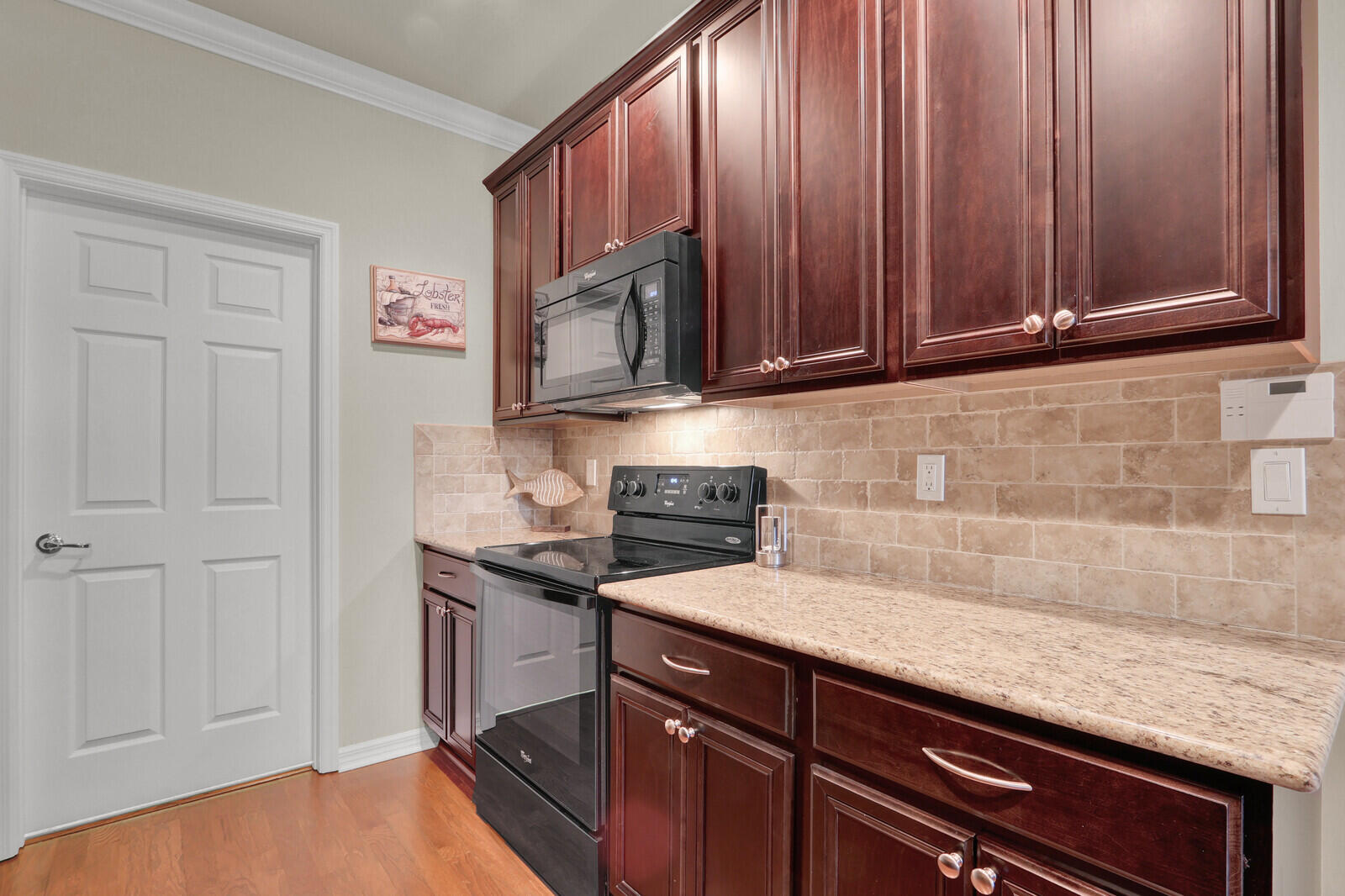 3277 East Mallory Boulevard Jupiter, FL 33458 - Photo 15 of 44 a kitchen with granite countertop cabinets stainless steel appliances and a counter space