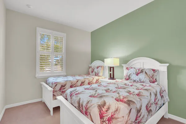 a bedroom with a bed and a lamp