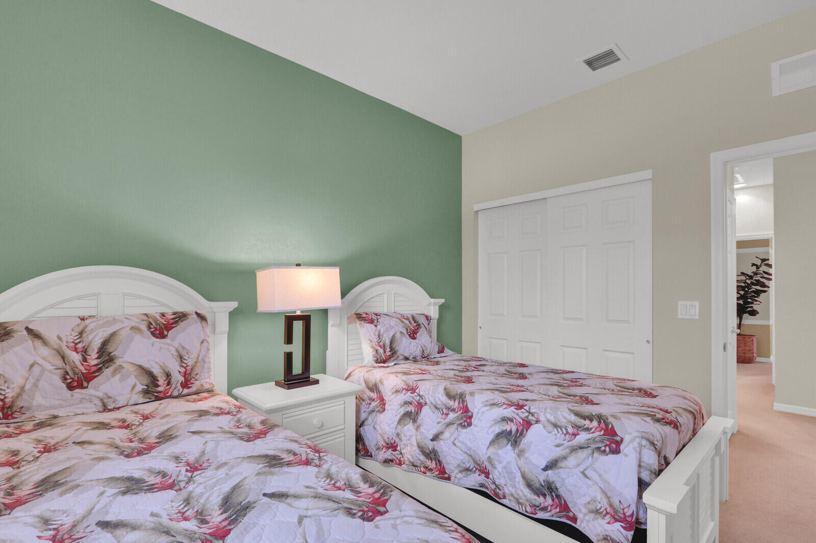 3277 East Mallory Boulevard Jupiter, FL 33458 - Photo 26 of 44 a bedroom with a bed and a lamp