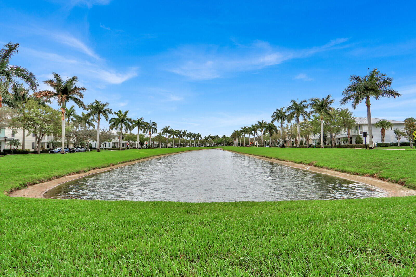 3277 East Mallory Boulevard Jupiter, FL 33458 - Photo 40 of 44 a view of a fountain in front of a house with a big yard