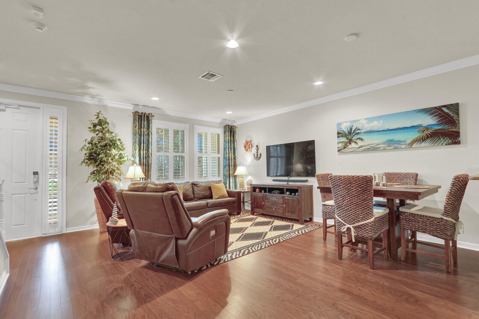3277 East Mallory Boulevard Jupiter, FL 33458 - Photo 7 of 44 a living room with furniture a flat screen tv and wooden floor