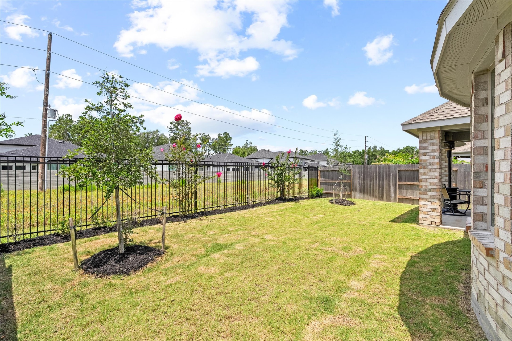 17270 Wild Watermelon Way Conroe, TX 77302 - Photo 26 of 28 Beyond the back fence sits open green space, giving you that extra breathing room and unobstructed view that is harder to find than you think.