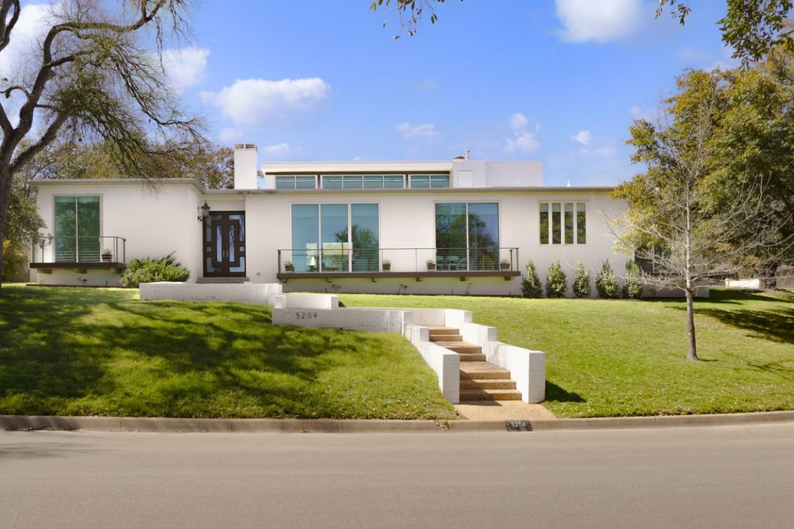 5204 Ridge Oak Drive Austin, TX 78731 - Photo 1 of 1 View of front of home featuring stucco siding, a front lawn, and a chimney