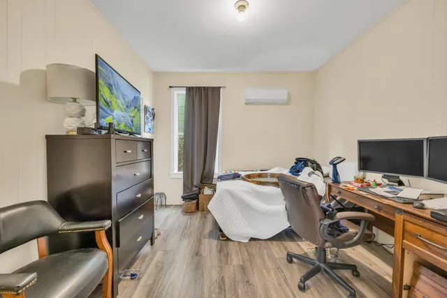 a bedroom with a bed and a chandelier