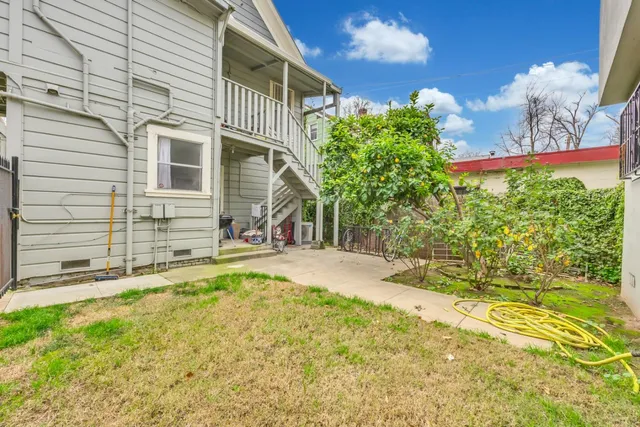 a view of a house with a patio and garden