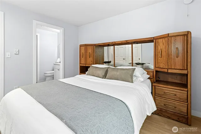 a bedroom with a bed and a large window