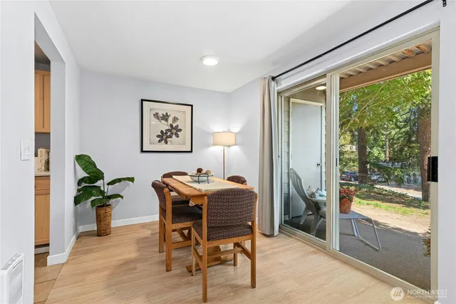 a dining room with furniture and a floor to ceiling window