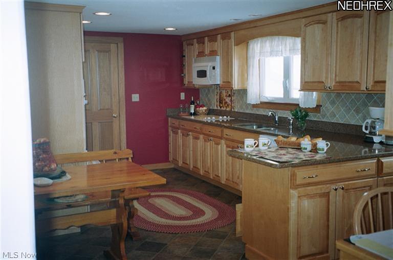 10809 Mitchells Mill Road Chardon, OH 44024 - Photo 3 of 16 This gorgeous kitchen has it all, fabulous maple cabinetry and quartz countertops, built-in desk and breakfast room.
