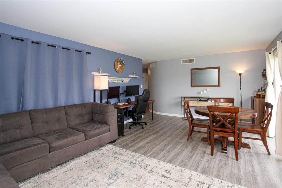 2300 Old Tavern Road, Unit 203 Lisle, IL 60532 - Photo 3 of 26 a living room with furniture and wooden floor