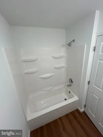 a bathroom with a bathtub and toilet
