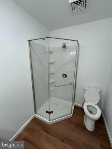 a bathroom with a toilet and a shower