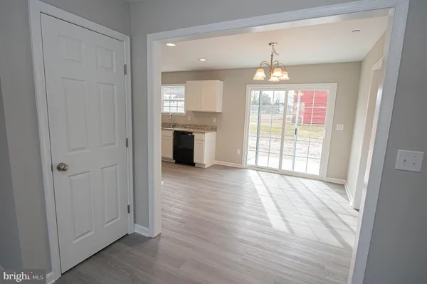 a open kitchen with a refrigerator and a stove top oven