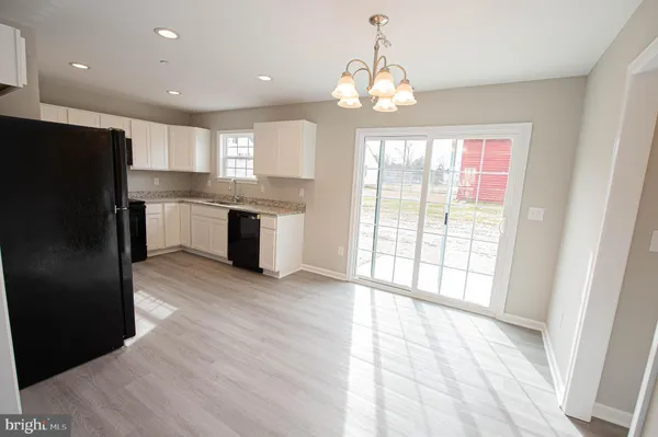 a kitchen with a refrigerator sink and stove top oven