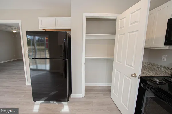 a kitchen with stainless steel appliances granite countertop a refrigerator a sink a stove and island