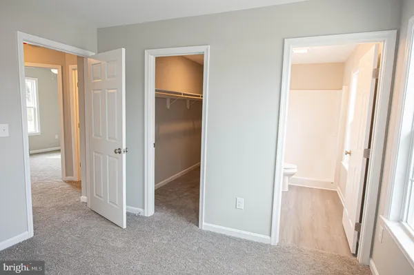 a bathroom with a toilet sink and a mirror