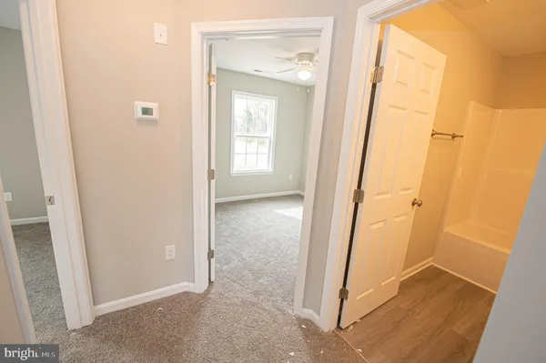 a bathroom with a toilet and a bath tub