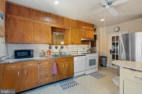 a kitchen with a sink cabinets and stainless steel appliances