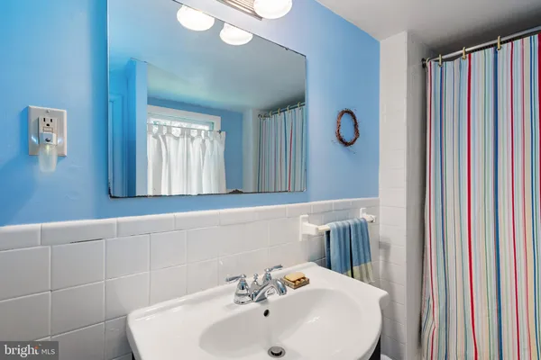 a bathroom with a sink a mirror and a window