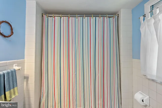 a view of a bedroom with a window and a shower