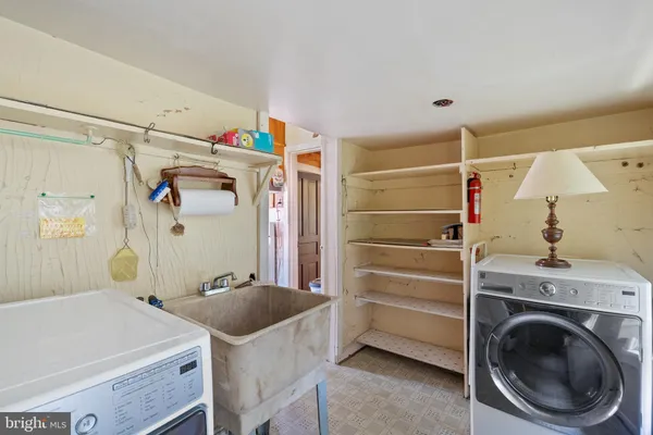 a bedroom with a bed and a refrigerator