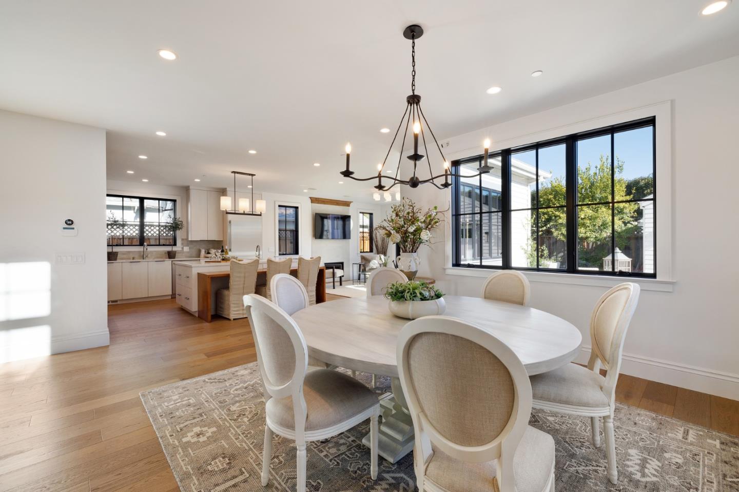 228 Stanley Road Burlingame, CA 94010 - Photo 26 of 100 a view of a dining room and livingroom with furniture wooden floor a chandelier