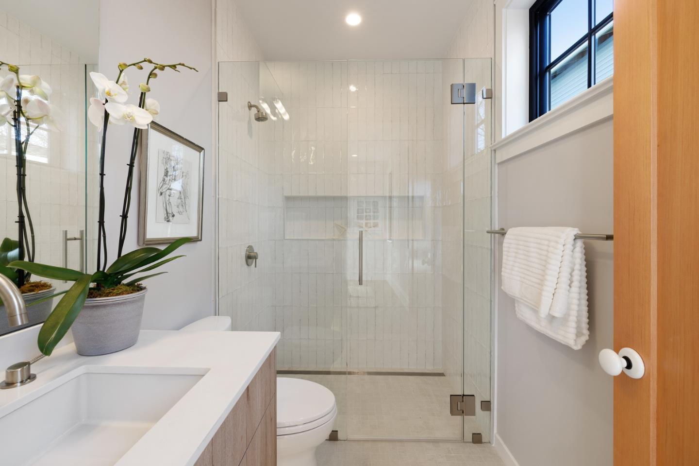228 Stanley Road Burlingame, CA 94010 - Photo 53 of 100 a bathroom with a granite countertop sink toilet a mirror a vanity and shower