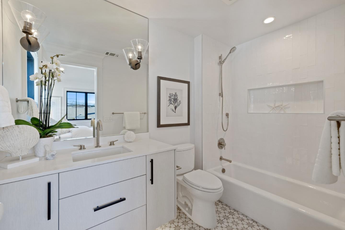 228 Stanley Road Burlingame, CA 94010 - Photo 75 of 100 a bathroom with a toilet a bath tub a sink and mirror