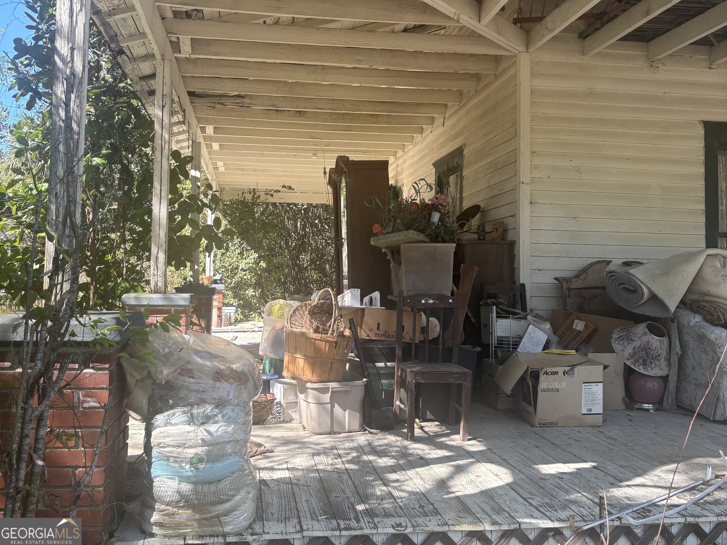13272 Florida Avenue St. George, GA 31562 - Photo 4 of 16 a view of a patio with table and chairs and potted plants