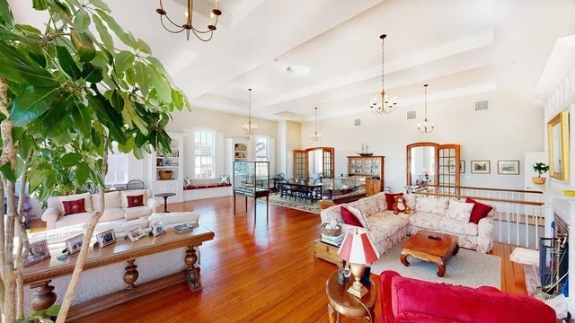 a living room with lots of furniture and wooden floor