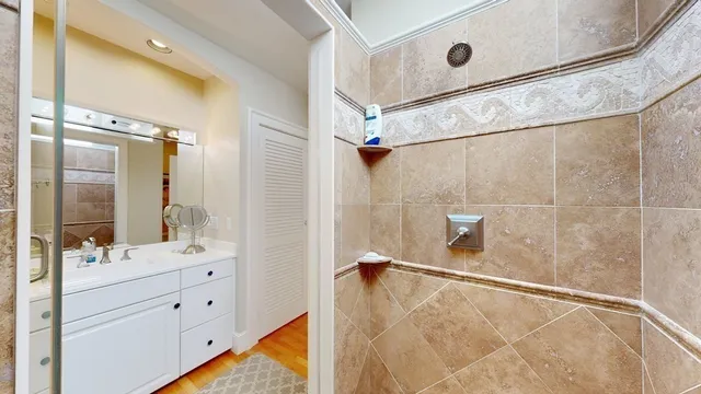 a bathroom with a sink mirror and vanity