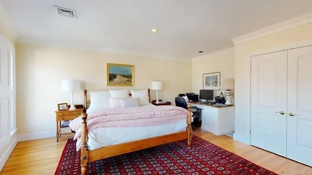 a bedroom with furniture and a large window