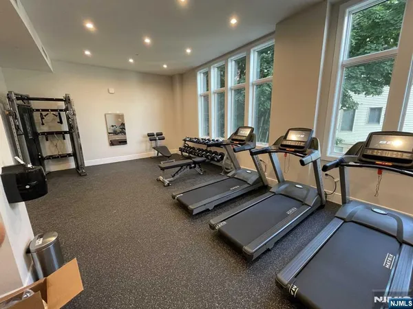 a room with gym equipment and a large window