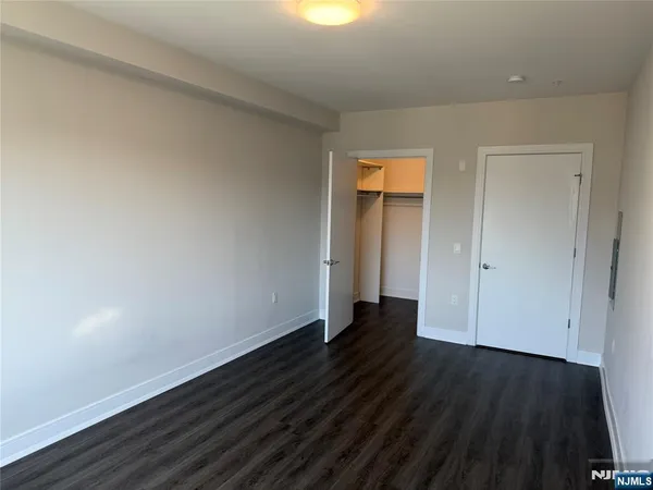 a view of an empty room and wooden floor