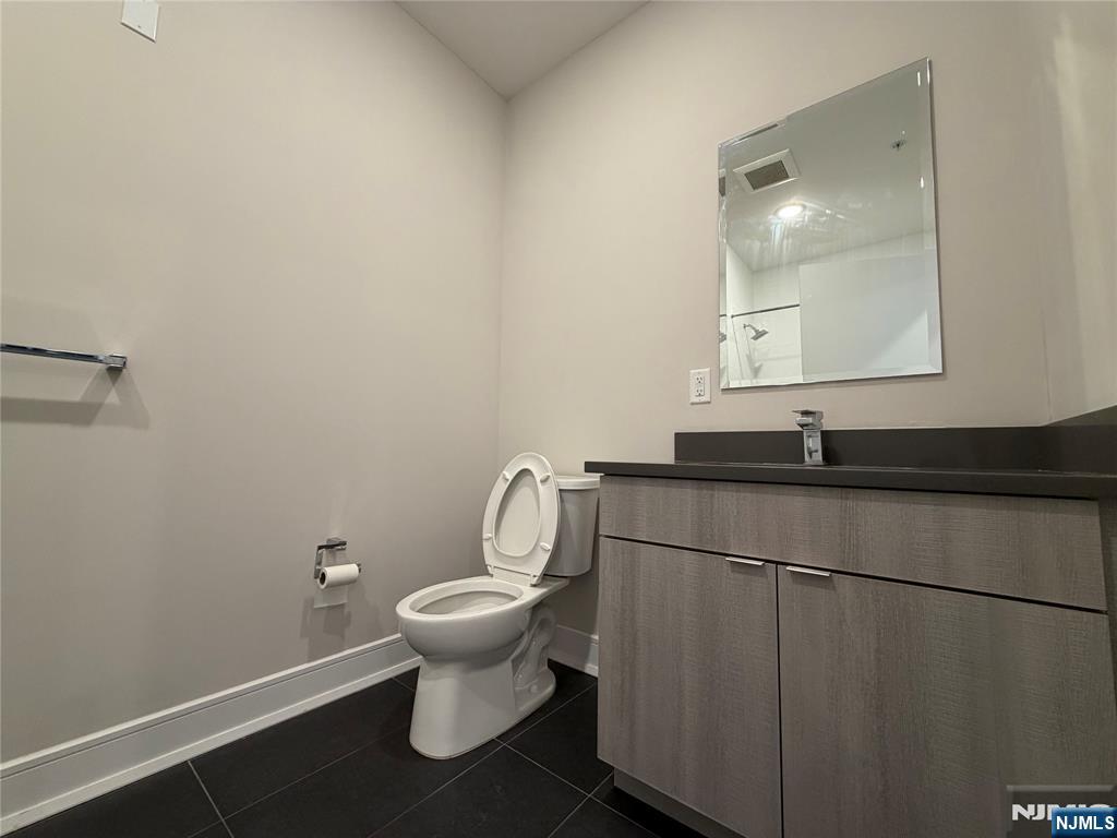 470 Main Street, Unit 412 Fort Lee, NJ 07024 - Photo 9 of 19 a bathroom with a sink and a toilet