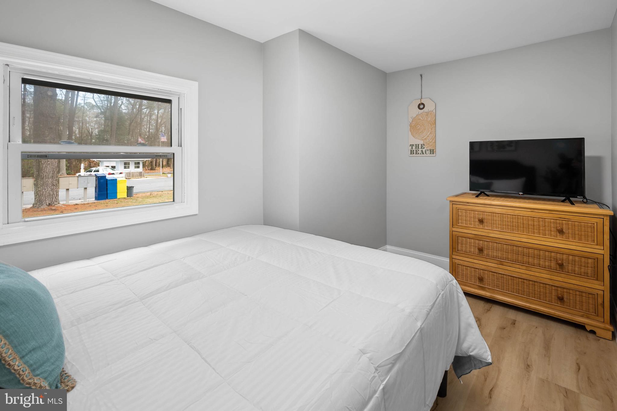 126 Skipjack Circle Berlin, MD 21811 - Photo 23 of 42 a bedroom with a bed and a flat screen tv