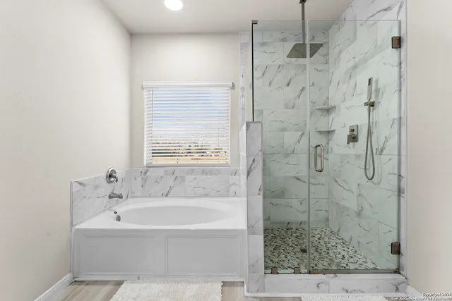 a spacious bathroom with a double vanity sink and a mirror