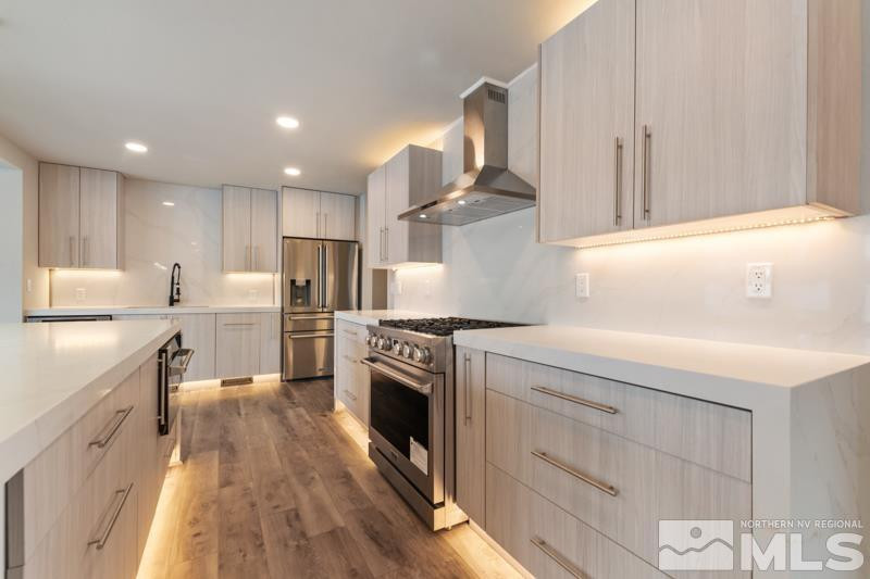 995 Skyline Boulevard Reno, NV 89509 - Photo 10 of 34 a kitchen with kitchen island a stove a sink and a refrigerator