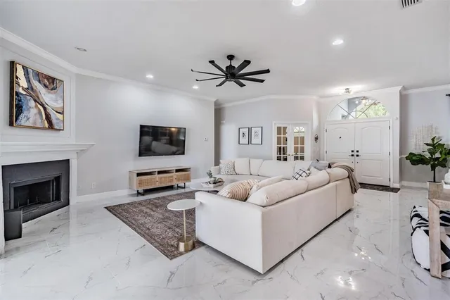 a living room with furniture a flat screen tv and a fireplace